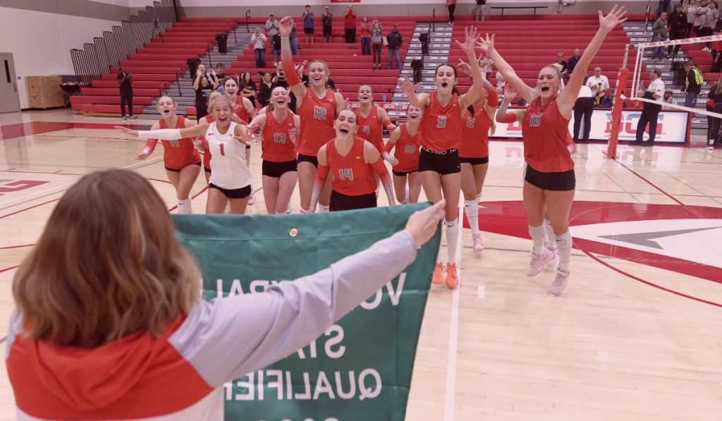 DCG to State Volleyball grabbing their banner to celebrate