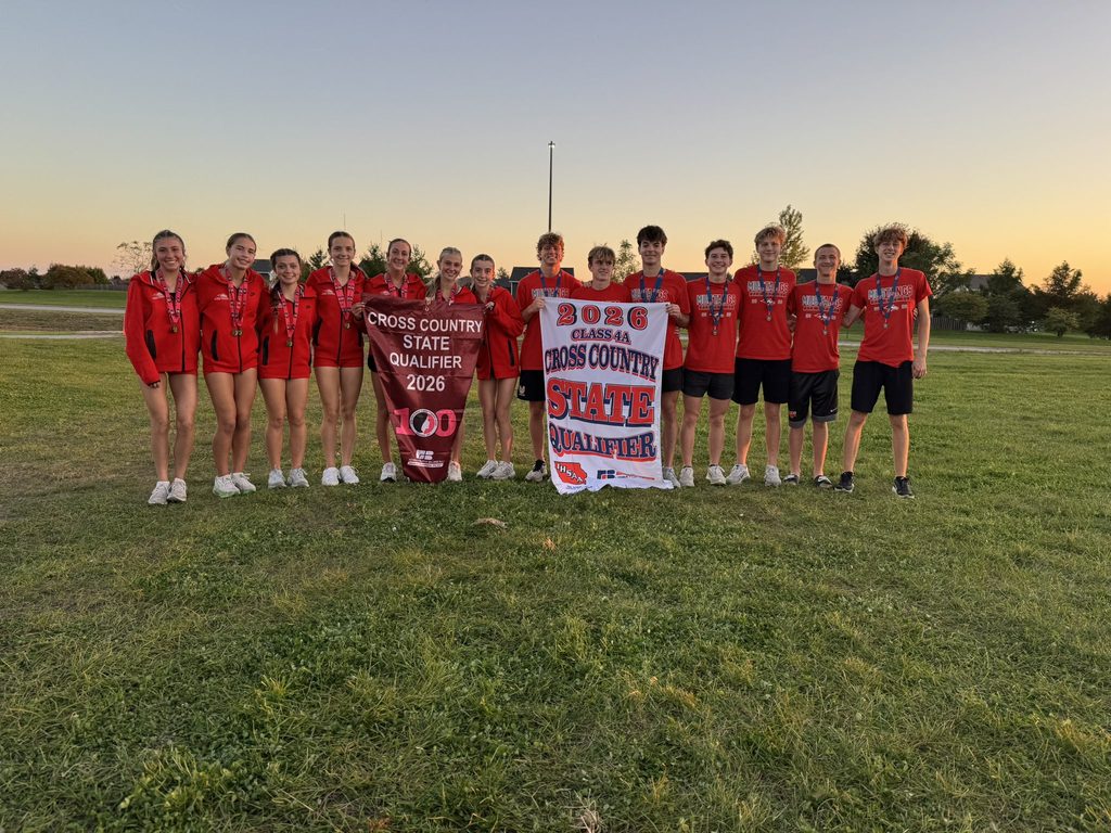 The DCG cross country teams hold up their state qualifying banners.